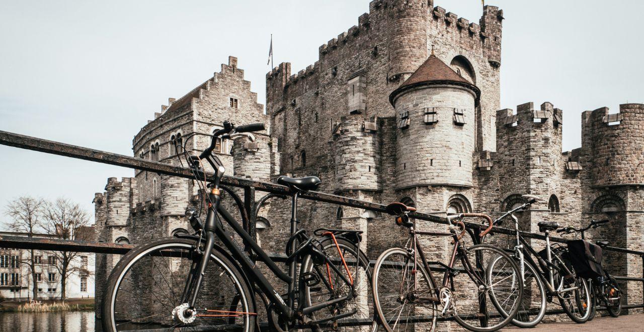 Bicycles parked in front of the historic Gravensteen Castle in Ghent.