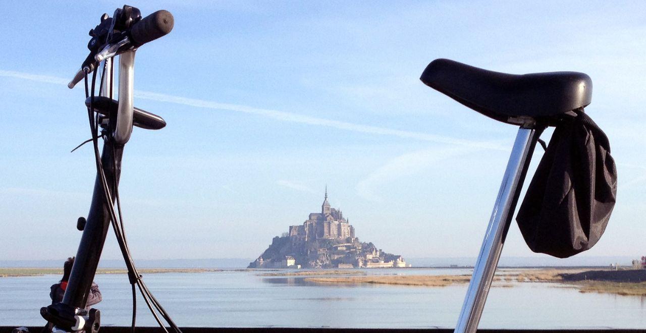 Bicycle with Mont Saint-Michel in the background.