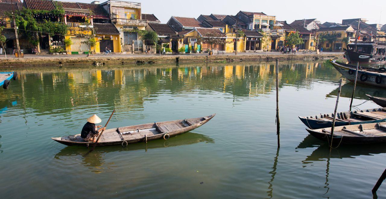 Traditional boat on a calm river, old town in the background