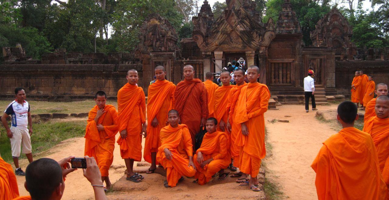 Group of Buddhist monks in orange robes at a temple