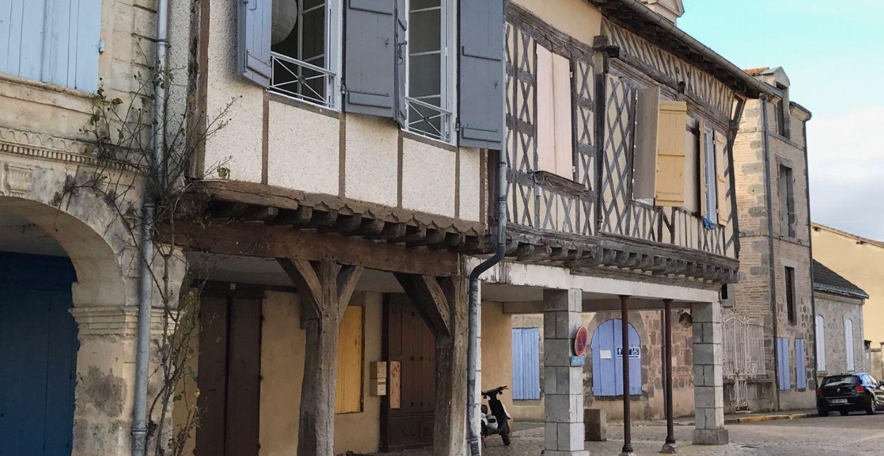 Half-timbered house with blue shutters in a French village.