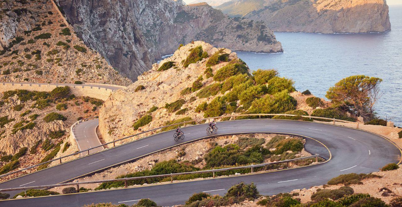 Cyclists riding on winding mountain road