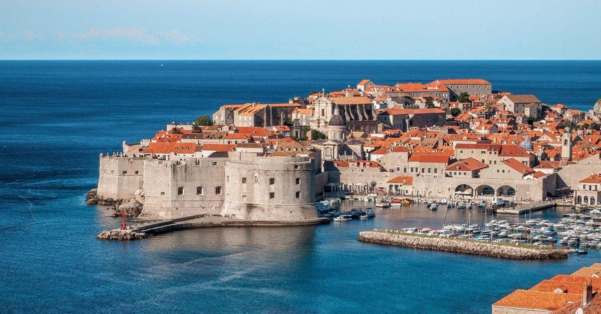 Historic coastal city of Dubrovnik with terracotta rooftops, fortified walls, and a serene harbour