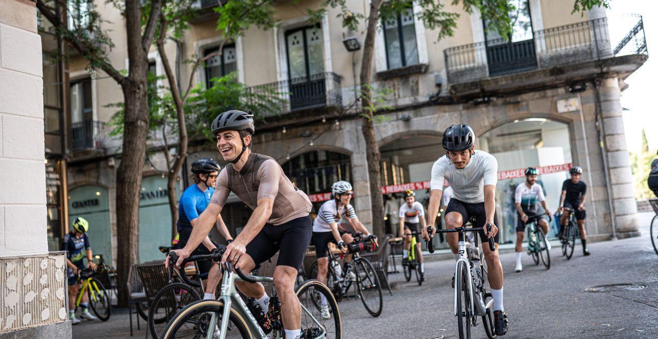 Group of cyclists riding in Girona city centre