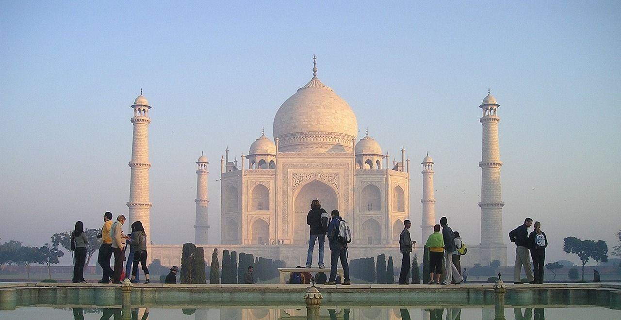 Tourists in front of the Taj Mahal at sunrise