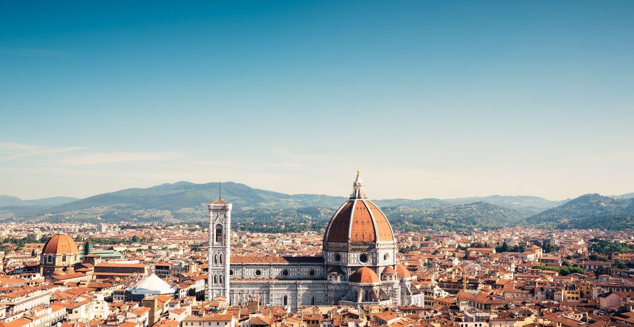 Aerial view of Florence with the iconic Duomo, bell tower, and surrounding Tuscan hills