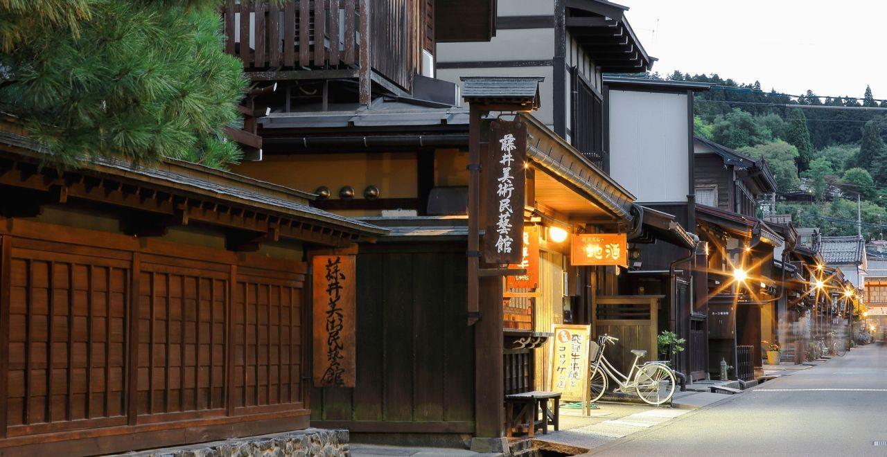 Charming Japanese street with wooden houses, evening lights