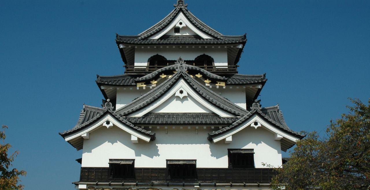 Traditional Japanese castle with white walls, blue sky