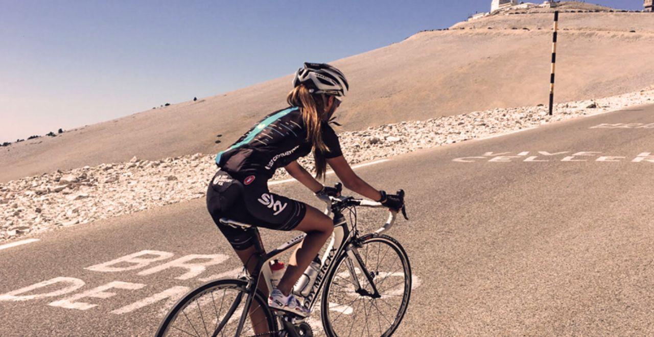 Female cyclist climbing the steep road towards the summit of Mont Ventoux.