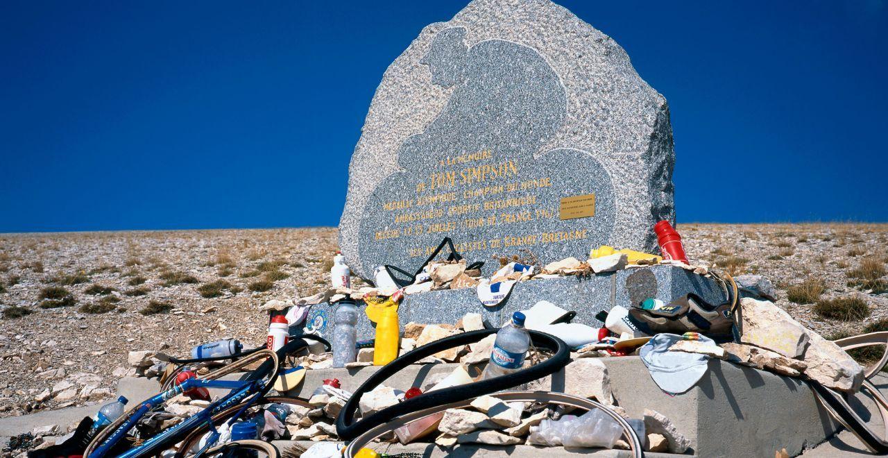 Memorial for cyclist Tom Simpson on Mont Ventoux with cycling memorabilia.