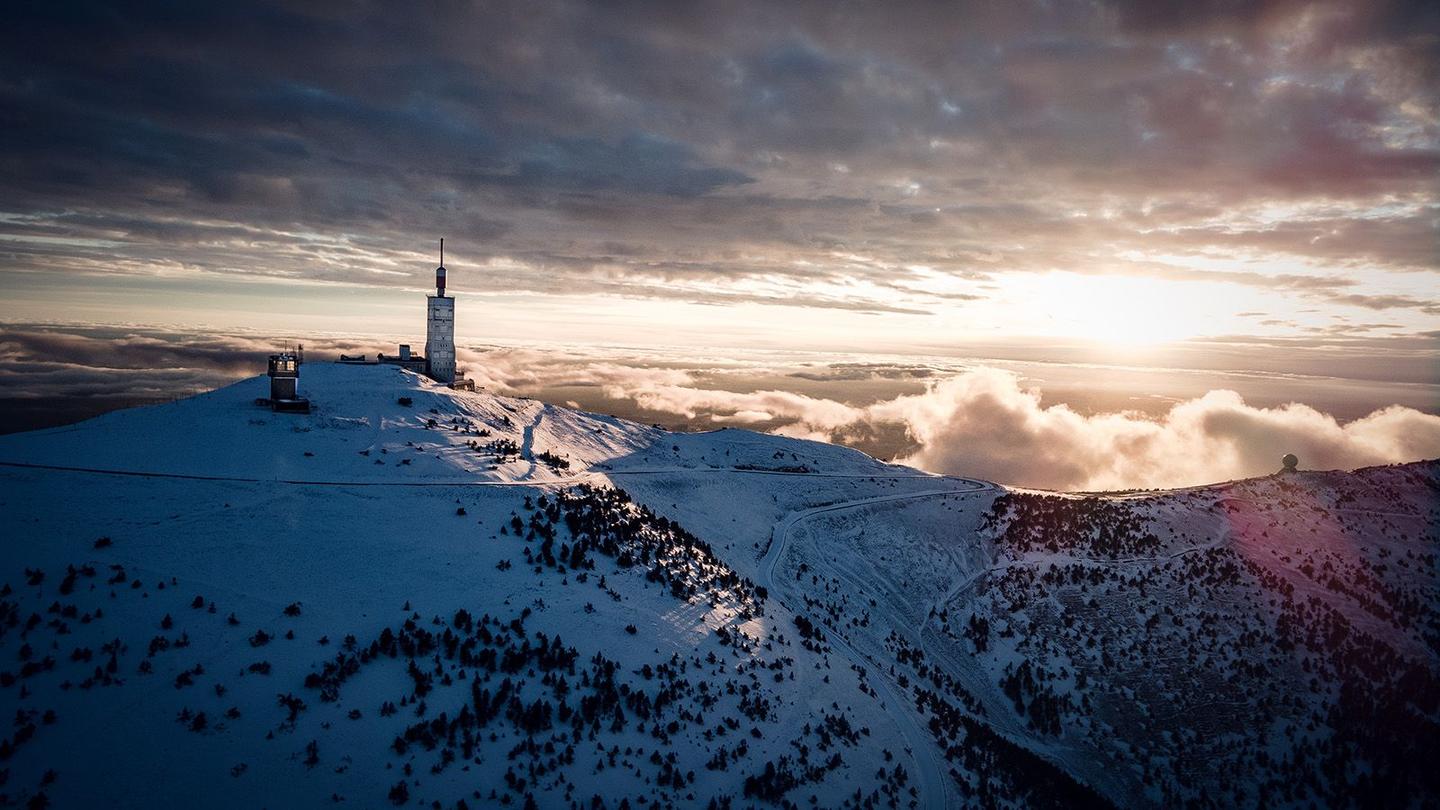 Sunrise over the snowy summit of Mont Ventoux, with the iconic weather station and dramatic cloud formations.