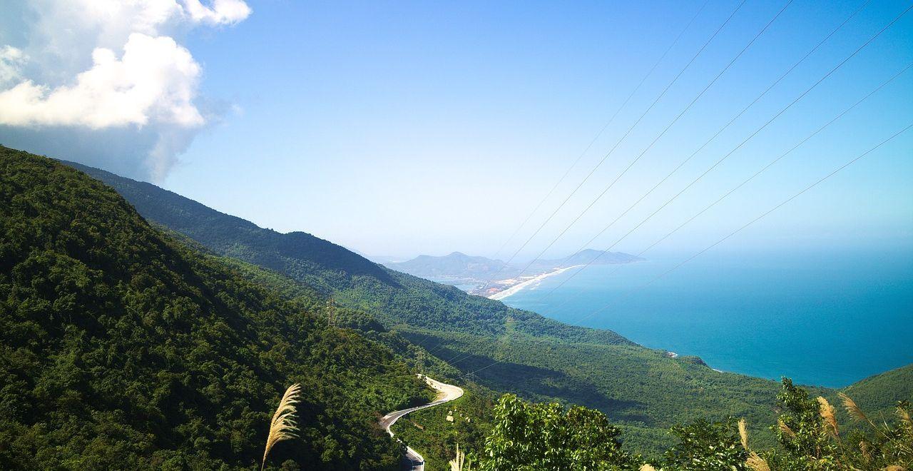 Scenic view of Hai Van Pass with lush mountains and ocean.