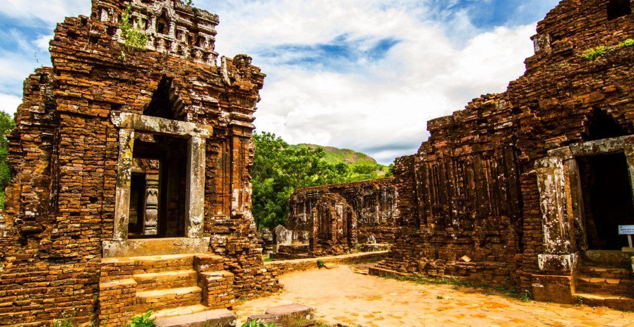 Ancient temple ruins nestled in the lush jungles of Vietnam, a majestic backdrop for cycling adventures