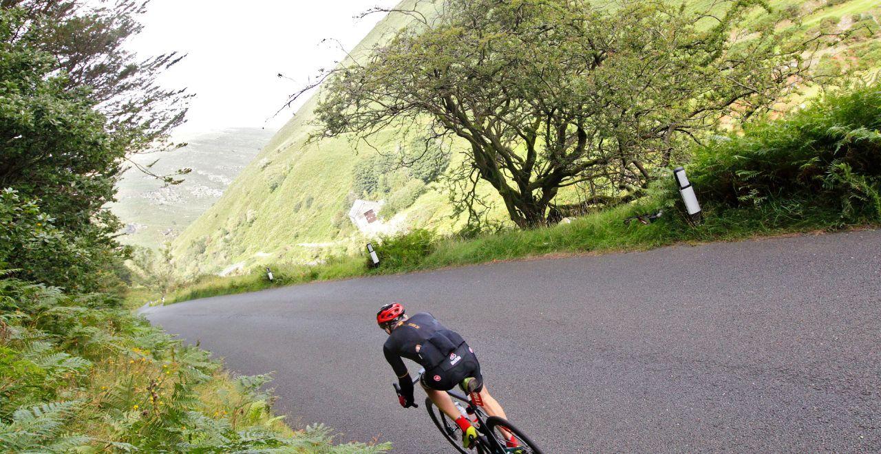 Cyclist taking a sharp turn on a mountain road