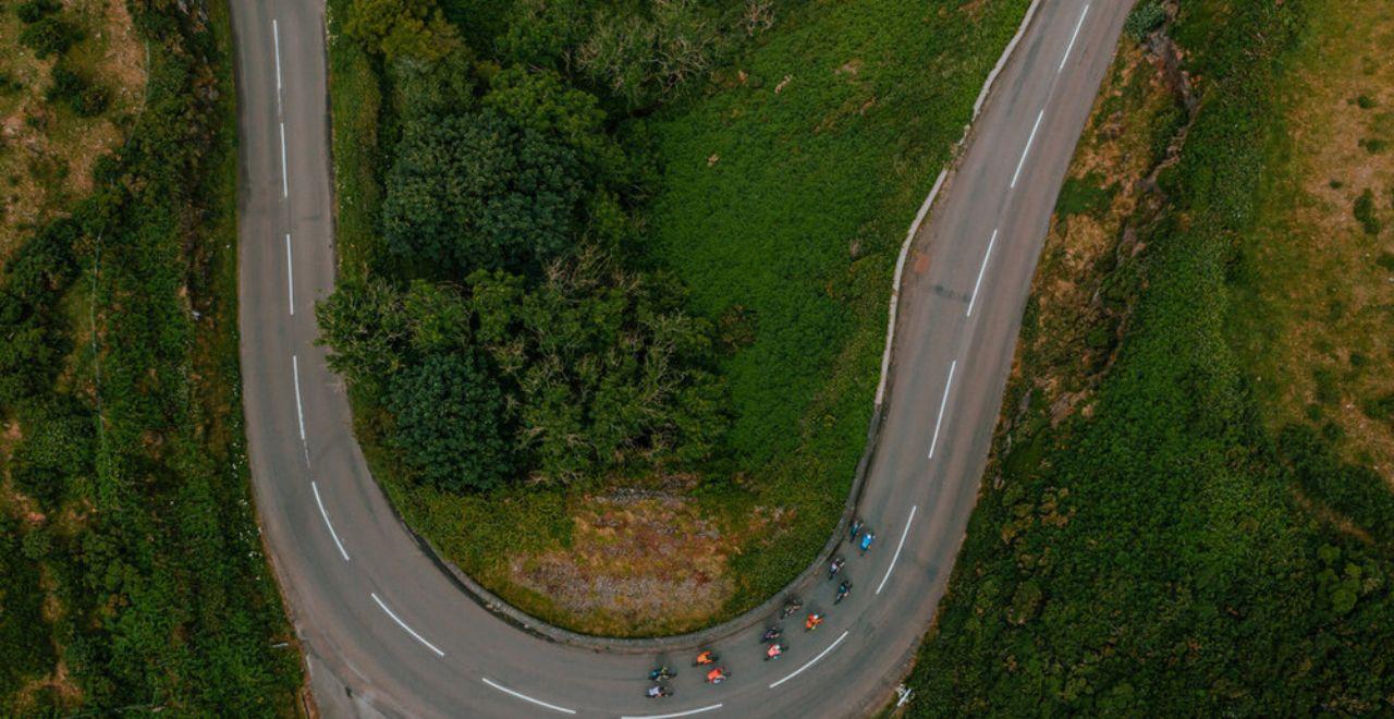 Aerial view of cyclists navigating a winding road