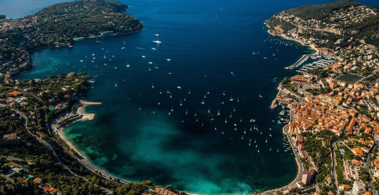 Aerial view of Villefranche sur mer with boats dotted along the bay