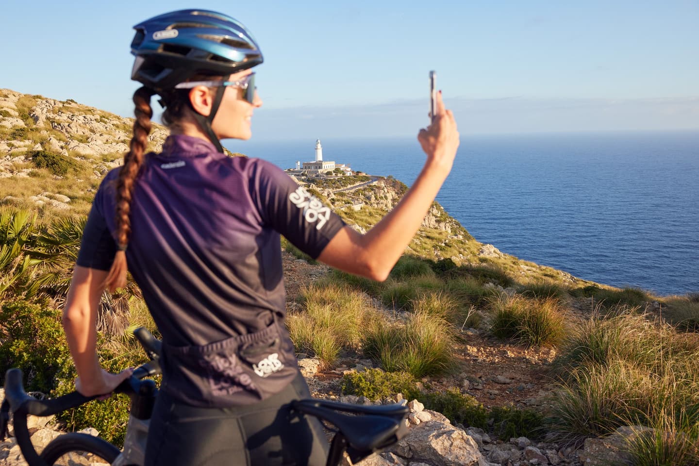 A woman riding a bicycle on a sunny day, enjoying the outdoors and the freedom of cycling.