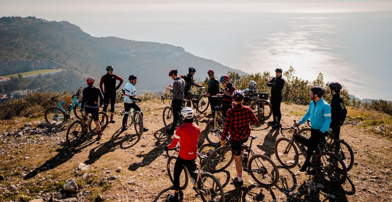 Group of cyclists gathering at scenic coastal viewpoint