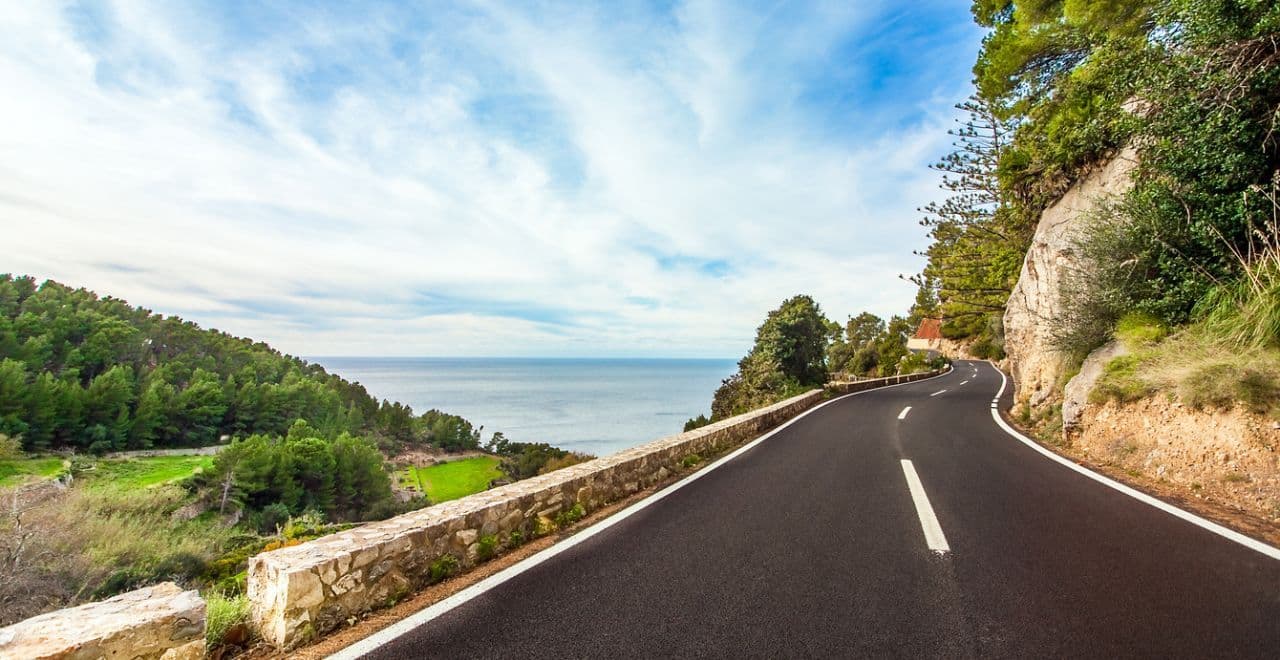 Coastal road with pristine tarmac and sea view in background