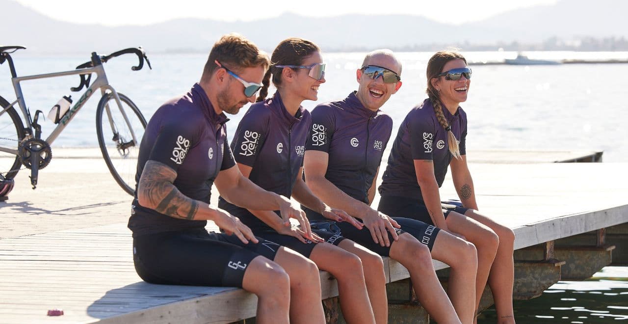 Cyclists relaxing on a dock by the water