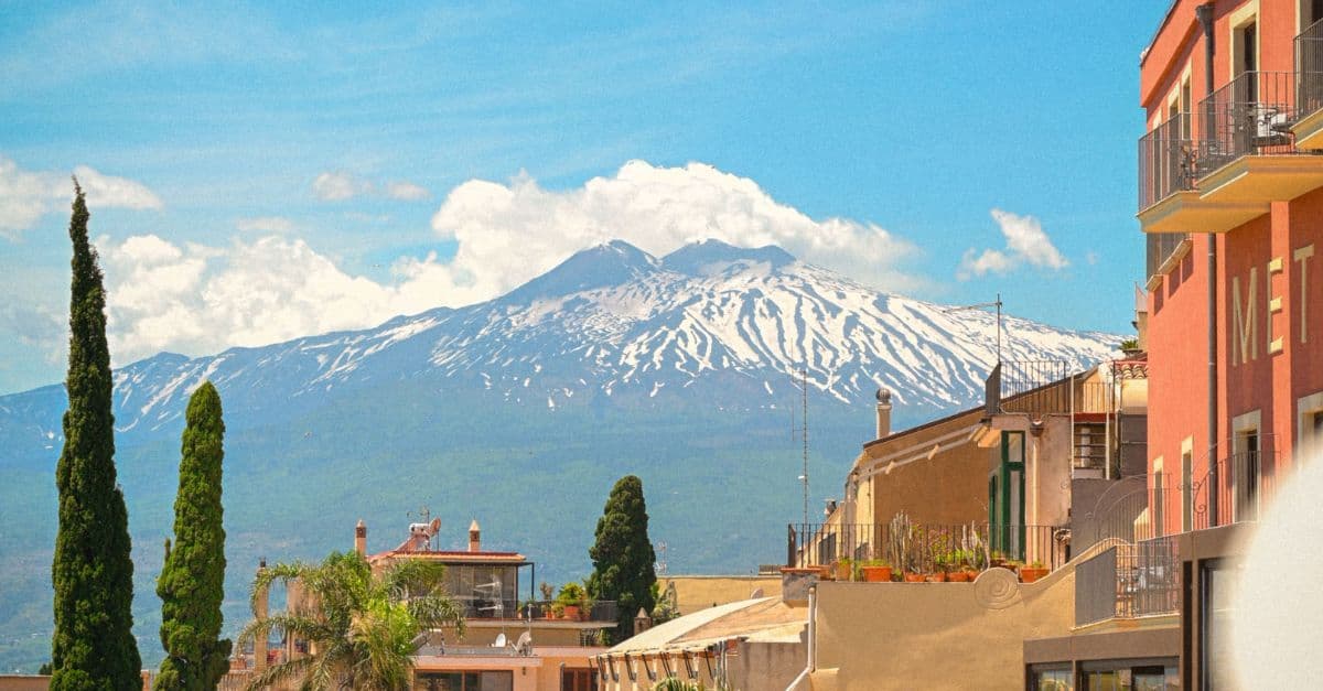 Taormina skyline with snow covered Mount Etna dominating the landscape.
