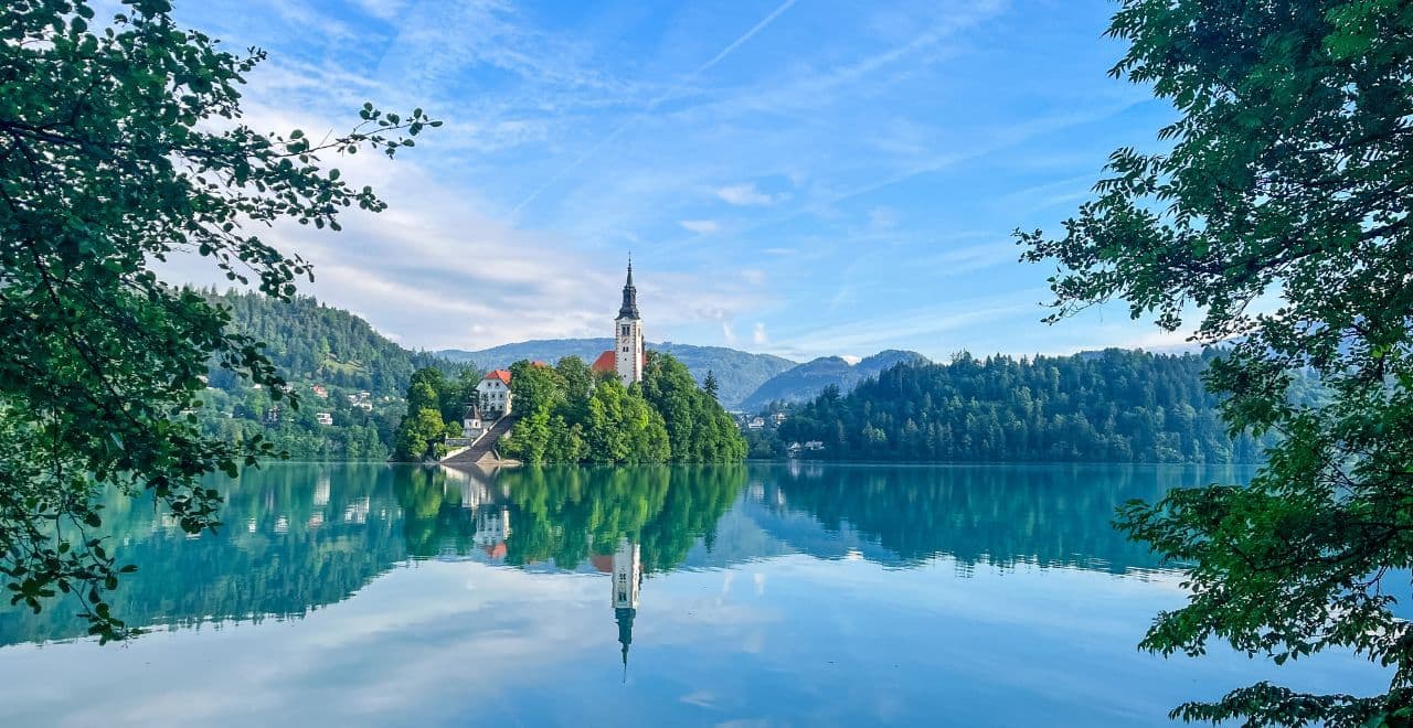 Church on an island reflected in the calm waters of Lake Bled