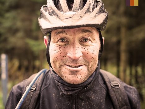 Cyclist with mud on his face 