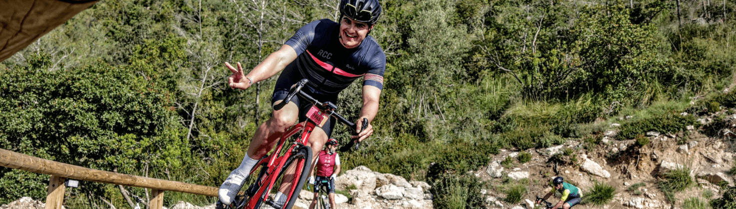Cyclist descending a climb in Mallorca smiling at the camera
