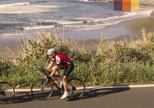 three cyclists riding among the sea in Tenerife