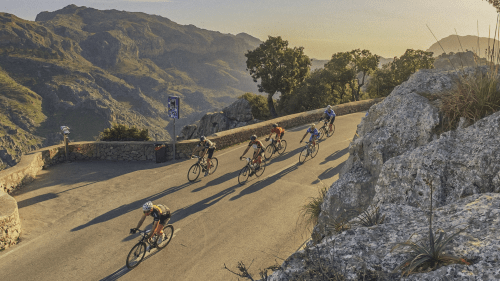 a group of cyclists riding on mountains in Mallorca
