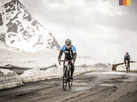 a road cyclist in cold weather on top of Passo Stelvio in Italy