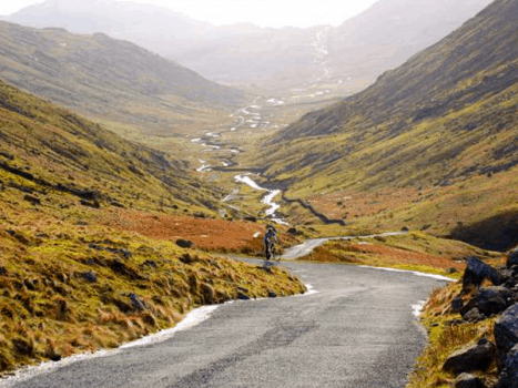 a road cyclist climbing hardknott pass in the lake district