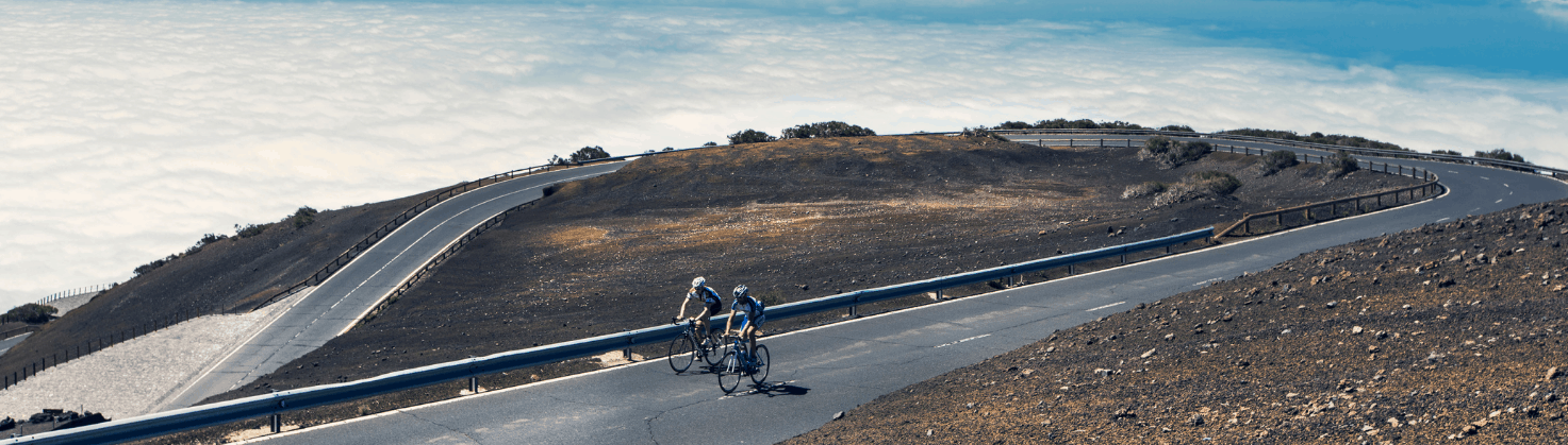 2 cyclists cycling up a road on Mount Teide in Tenerife