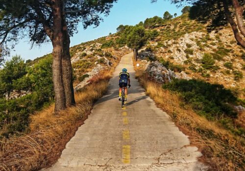 Cyclist riding up a grave road in Spain